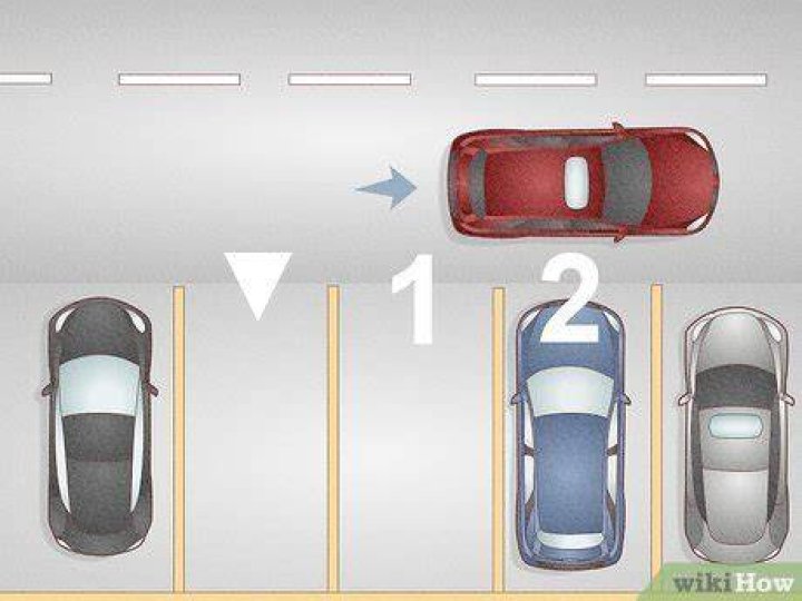 How do you signal when backing into a parking space?